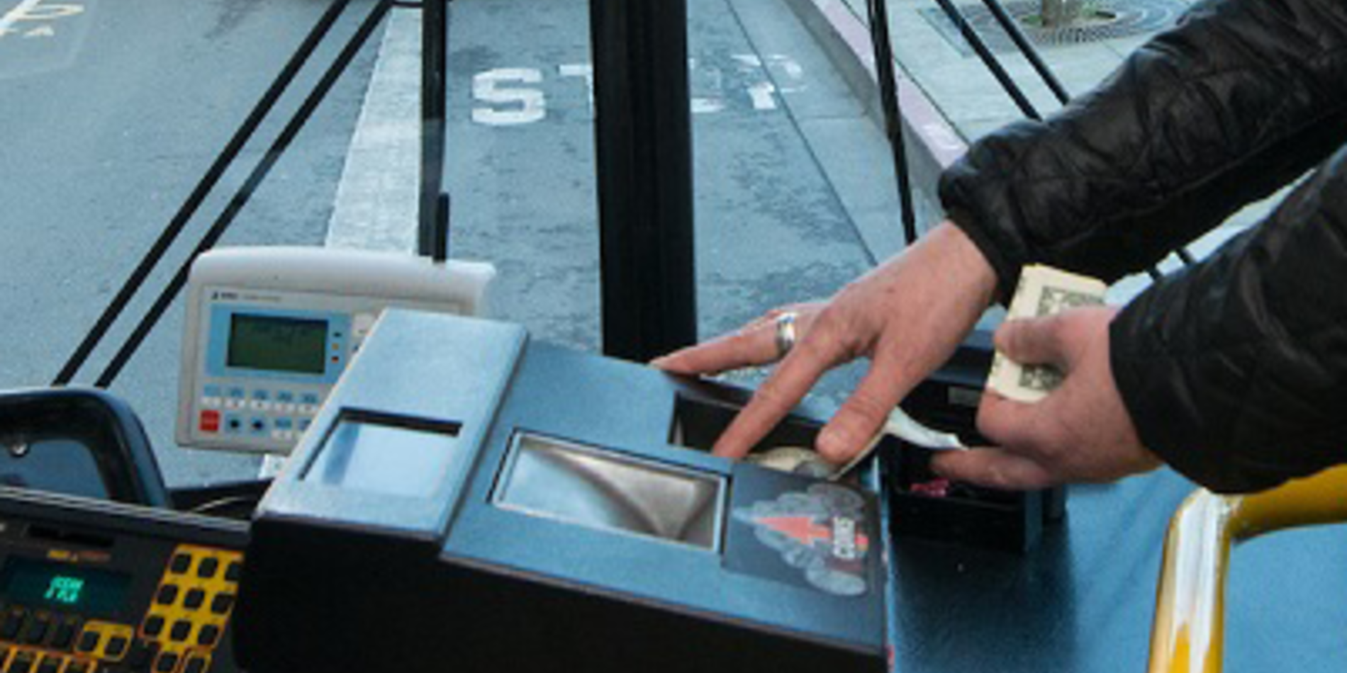 a woman scans her bus fare card as she enters the bus
