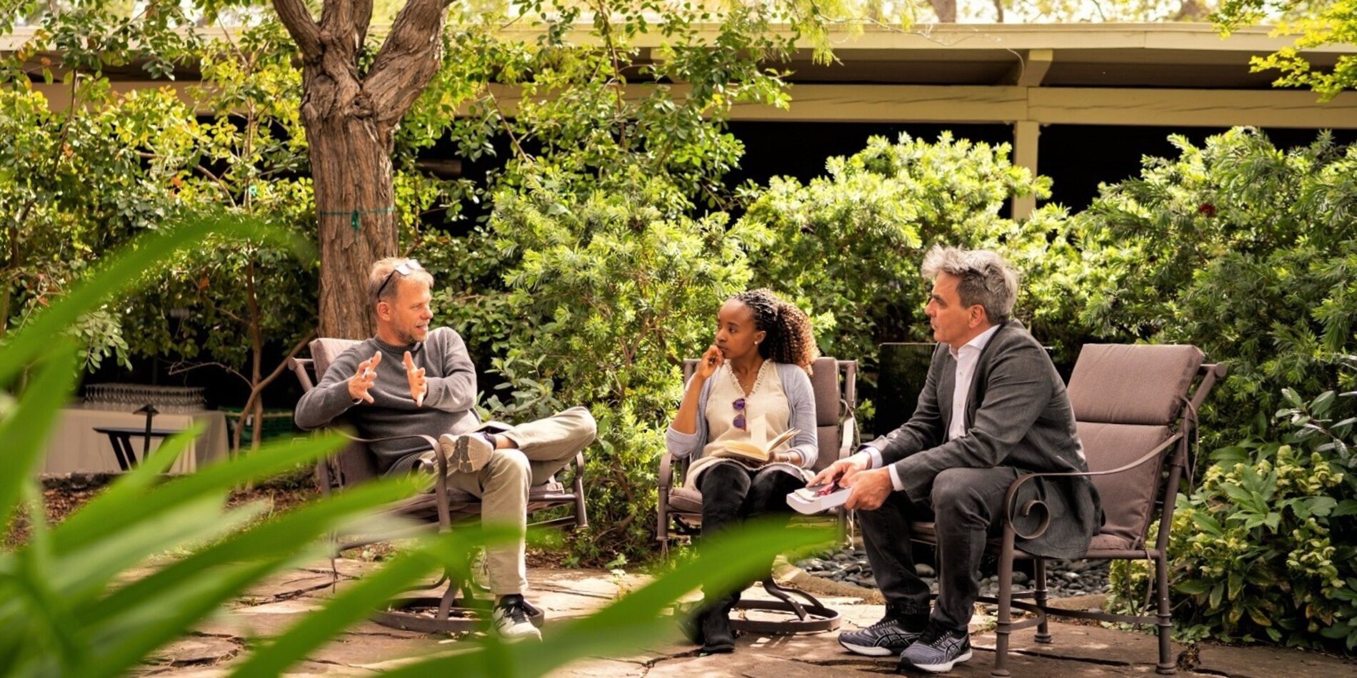 Three CASBS fellows engaging in conversation outdoors