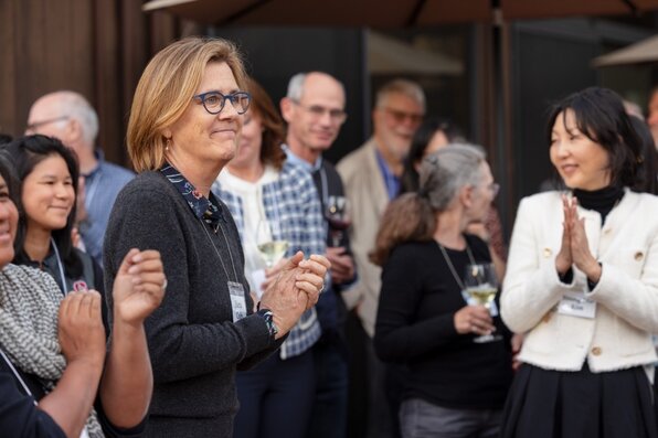 people standing and clapping