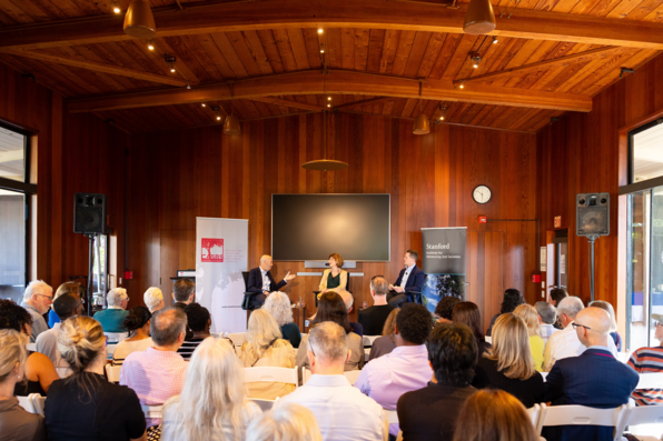 wide shot of Ian Goldin speaking with audience in foreground