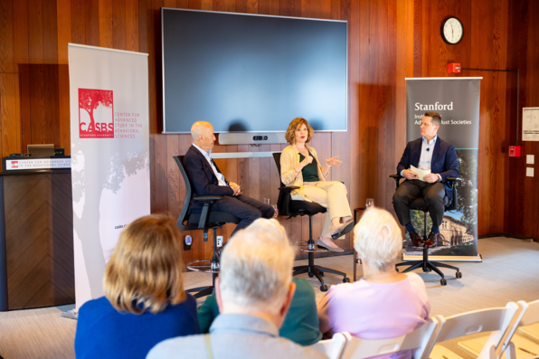 Rachel Peric speaks as Ian Goldin and Tomas Jimenez look on