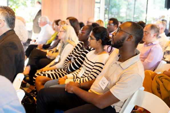 View of audience members watching and listening