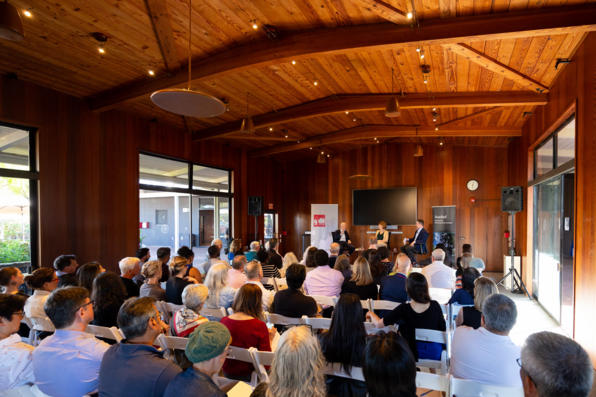 View of the cavernous event space as panel discussion continues