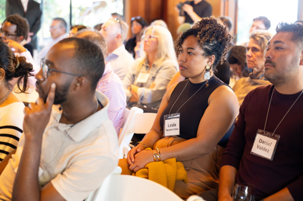 View of audience members watching and listening to the panel discussion