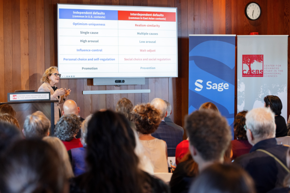 Hazel Markus speaking, the CASBS and Sage retractable banners prominently displayed