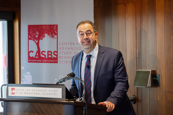 Daron Acemoglu speaking at the lectern