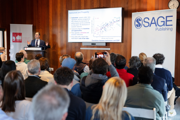 Daron Acemoglu speaking in front of the audience