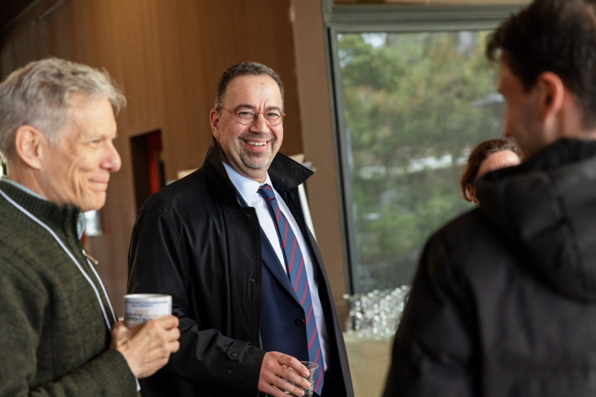 Daron Acemoglu mingling before the start of the event