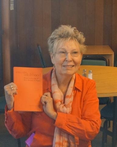 Phyllis Moen holding up a book she published 