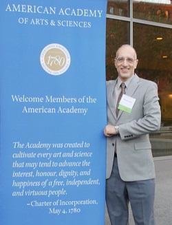 Martin Gilens poses next to an AAAS banner