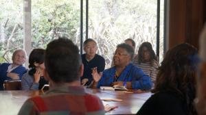 A speaker at a workshop conference table