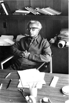 M. N. Srinivas sits at a desk looking pensive